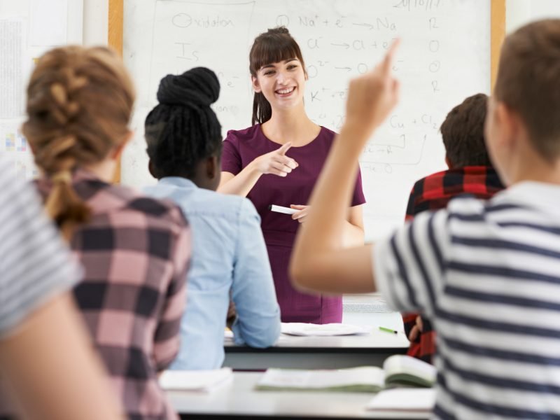 Teenage Pupil Answering Question In Class Teenage Pupil Answering Question In Class